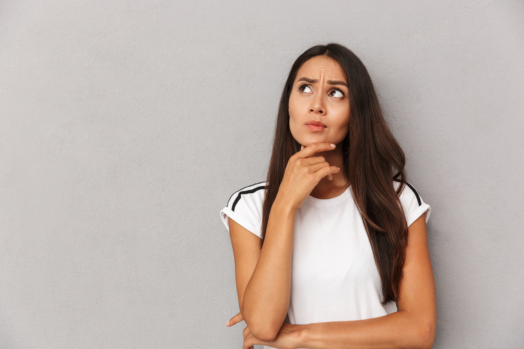 Woman Isolated over Grey Background Looking Aside.